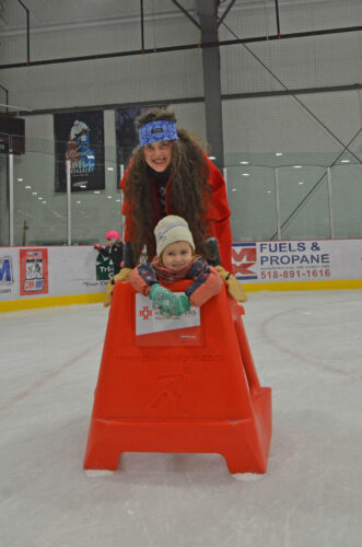 Tove, 3, and Stephanie Sears smile and glide at the Skate with Santa Christmas Eve event at the Saranac Lake Civic Center on Wednesday. (Enterprise photo — Aaron Marbone)
